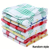 A stack of plaid microfiber dish towels in various green, red, and white patterns.