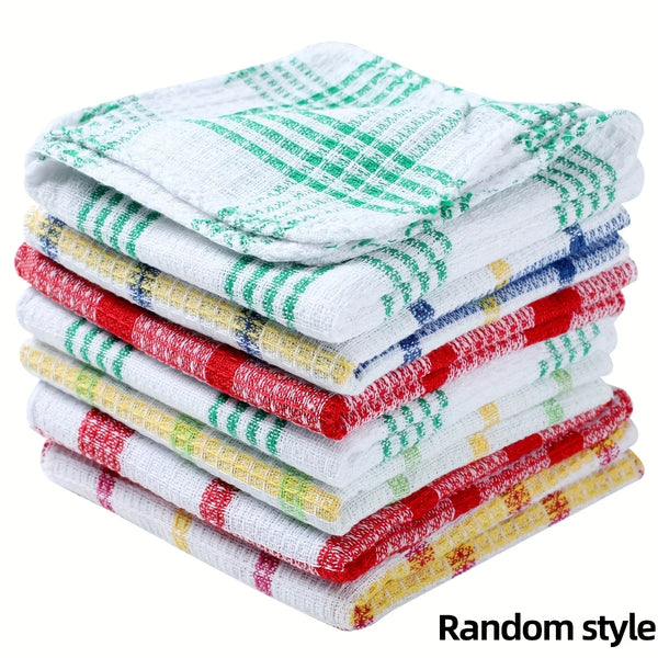 A stack of plaid microfiber dish towels in various green, red, and white patterns.