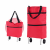 A bright red foldable shopping bag with black handles and wheels.