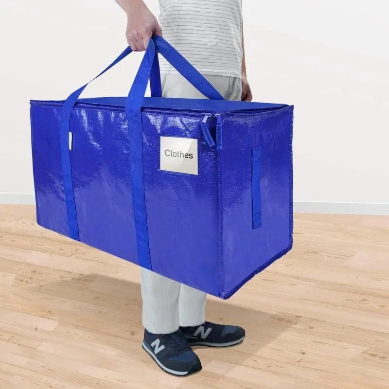 A bright blue heavy duty extra large moving bag with handles is being held by a person.