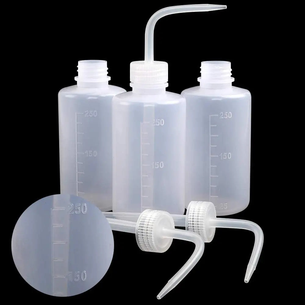 A clear plastic squeeze bottle and a circular measuring disk with volume markings for tattoo solutions.