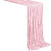 A pink boho sheer table runner draped diagonally.
