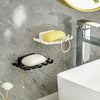 Wall mounted soap dish rack with white and yellow soap on a gray marble bathroom wall.
