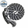 A black and white graduation honor cord with tassel ends coiled in a spiral.