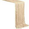 A beige boho sheer table runner with vertical pleats draped diagonally.