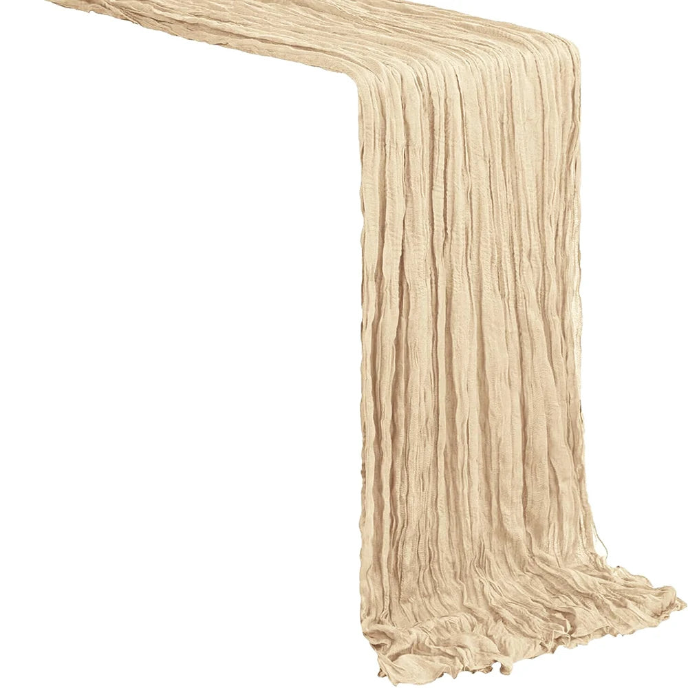 A beige boho sheer table runner with vertical pleats draped diagonally.