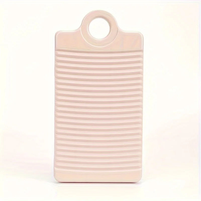 A light pink portable anti-slip wash basin with ribbed texture.