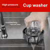 A hand is using a high-pressure cup washer to clean a glass in a commercial or domestic setting.