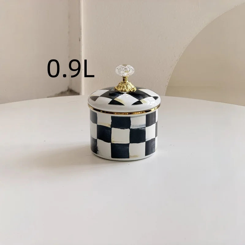 A small 0.9L retro enamel storage jar with a checkered black and white pattern and a gold-toned lid.