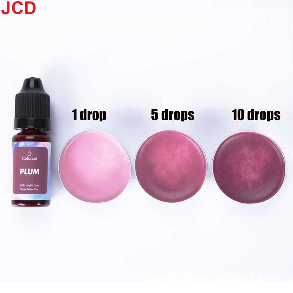 A set of liquid candle dye in plum color shown with dropper bottles and various amounts of liquid drops