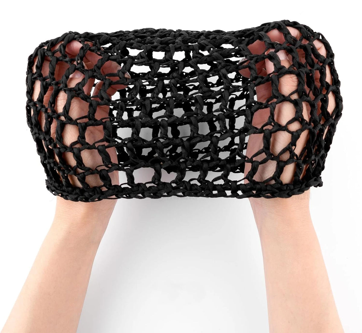 A close-up of a black adjustable mesh wig cap being worn on a person's head.