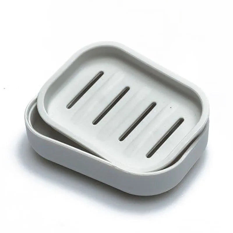 A white double layer drain soap dish with three slots for soap