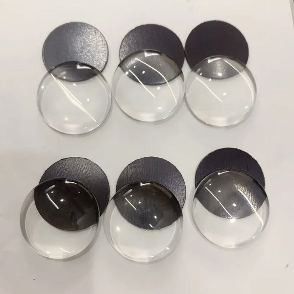 A set of decorative glass refrigerator magnets in various shades of gray and black.