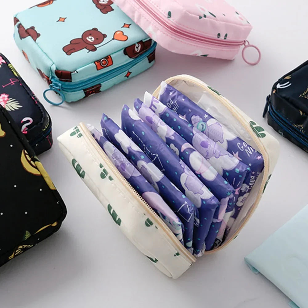 A collection of purple and white sanitary pads stored in a beige nylon pouch alongside various fabric pouches.