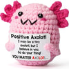Handmade pink crochet axolotl figurine with black eyes and pink gills