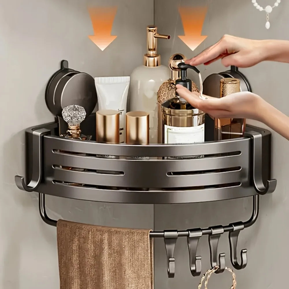 A stainless steel triangular suction cup storage shelf holding various toiletries and a hanging towel.