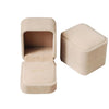 A light beige velvet jewelry box with a hinged lid, shown in a side view.