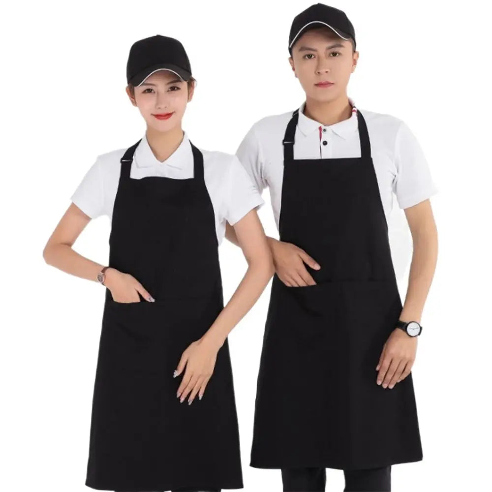 Two models wearing classic black chef aprons with large front pockets