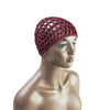 A model wears a deep red hand-crocheted mesh hair net cap on her head.