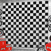 A seamless black and white checkered foil curtain backdrop with a distressed wood texture.