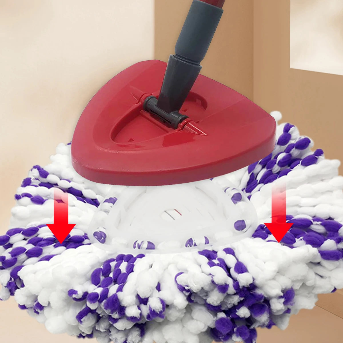 A red replacement mop head is shown being attached to a white spinning mop head.