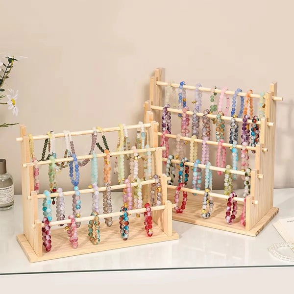Solid wood ladder jewelry organizer displaying various colorful beaded necklaces on multiple tiers