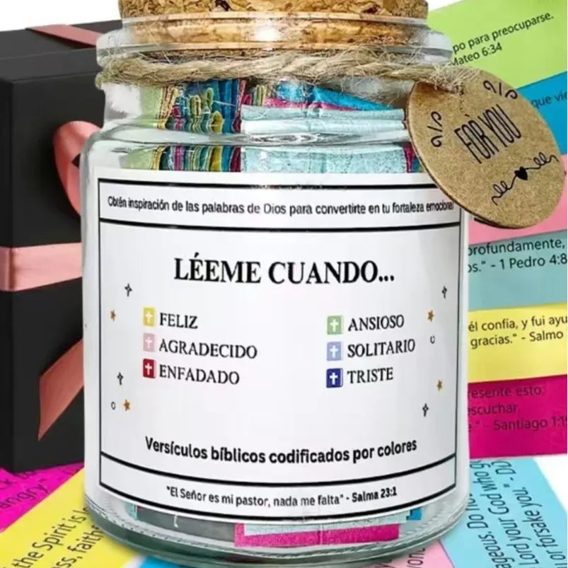 A glass jar filled with bible verses coded by colors and a straw lid