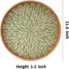 Round rattan serving tray with a light green, fan-like pattern and mother of pearl inlay.