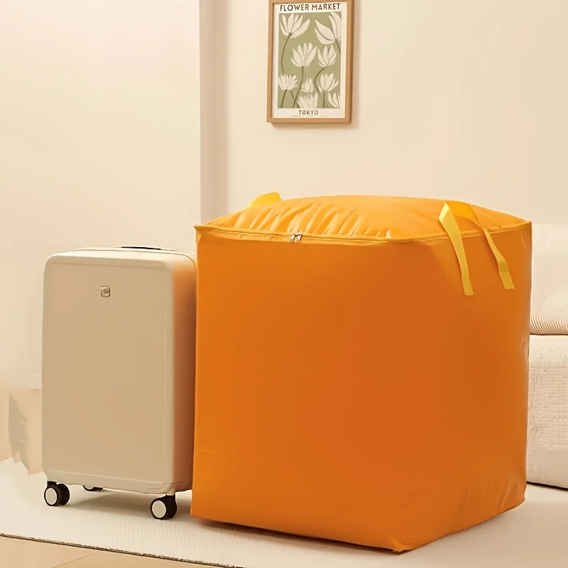 An orange heavy-duty waterproof storage bag next to a white suitcase on a light-colored floor.