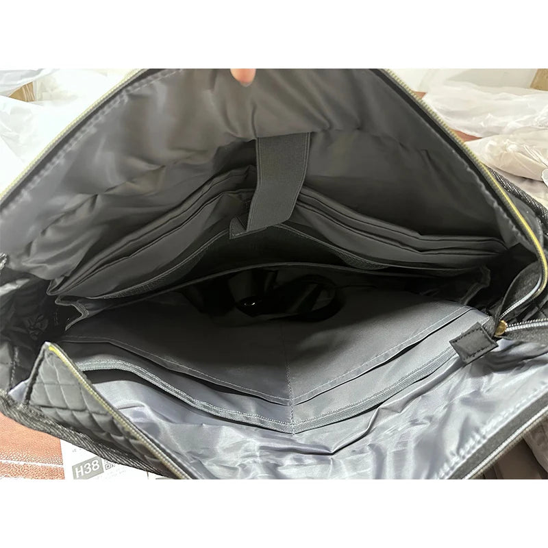 Interior view of a dark gray quilted multi-pocket tote bag showing its lining and organization features.