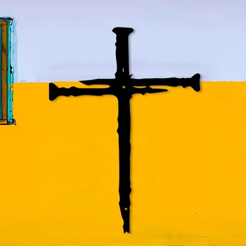 A black metal cross silhouette is painted on a bright yellow wall against a light purple background.