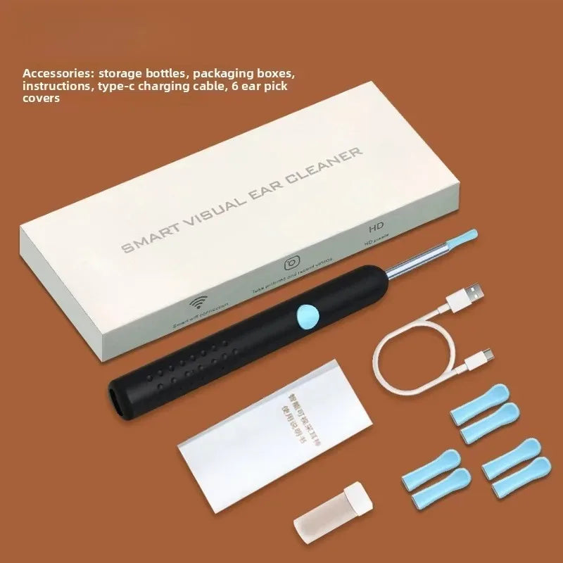 A white box and a black visual ear cleaner tool with an LED camera and various accessories are displayed on a brown surface.