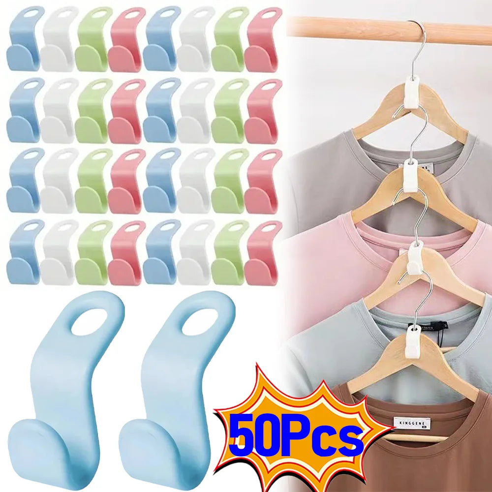 A collection of light colored plastic clothes hanger hooks in various pastel shades, shown alongside wooden hangers.