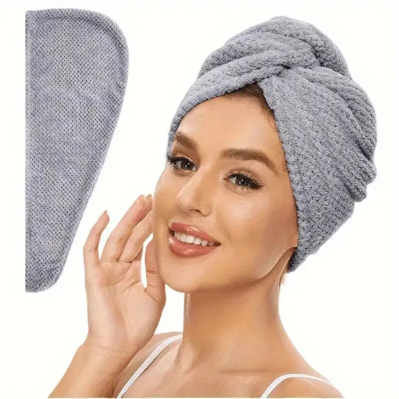 A woman is wearing a gray soft microfiber hair drying towel wrap on her head.