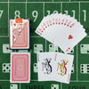 A green felt surface displays a deck of poker playing cards, including face cards and jokers.