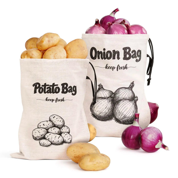 A white reusable drawstring bag labeled Potato Bag filled with potatoes and a separate bag of red onions.