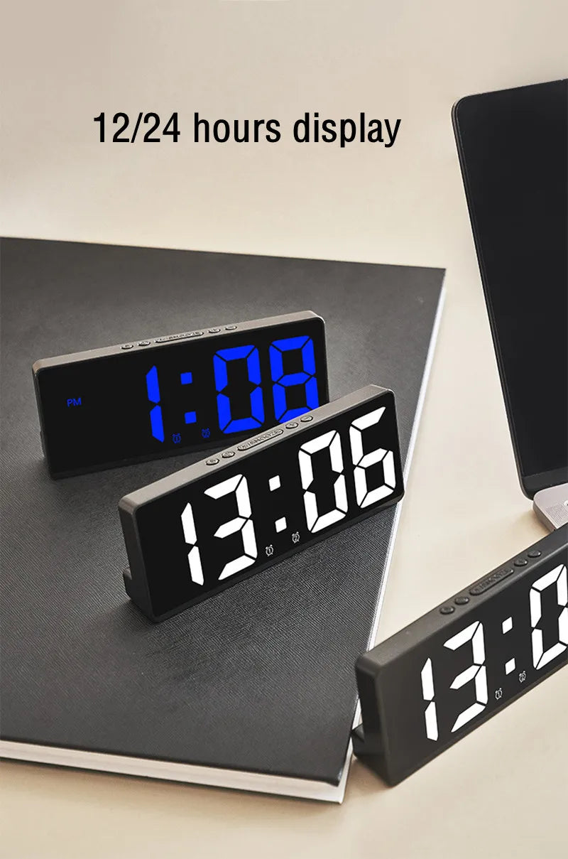 A black digital alarm clock displaying 1:08 on a dark surface.