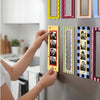 A hand is placing a magnetic photo frame set featuring portraits on a refrigerator