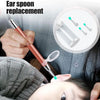A hand is using a replacement ear spoon for otoscope cleaning on a child's ear.