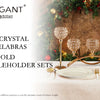 A set of three gold crystal candelabras and candleholders displayed on a table with greenery in the background.