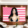 A woman with long dark hair is featured on a decorative fabric banner with a pink and white American flag design.
