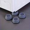 Three gray anti-vibration pads are shown under a white washing machine appliance.