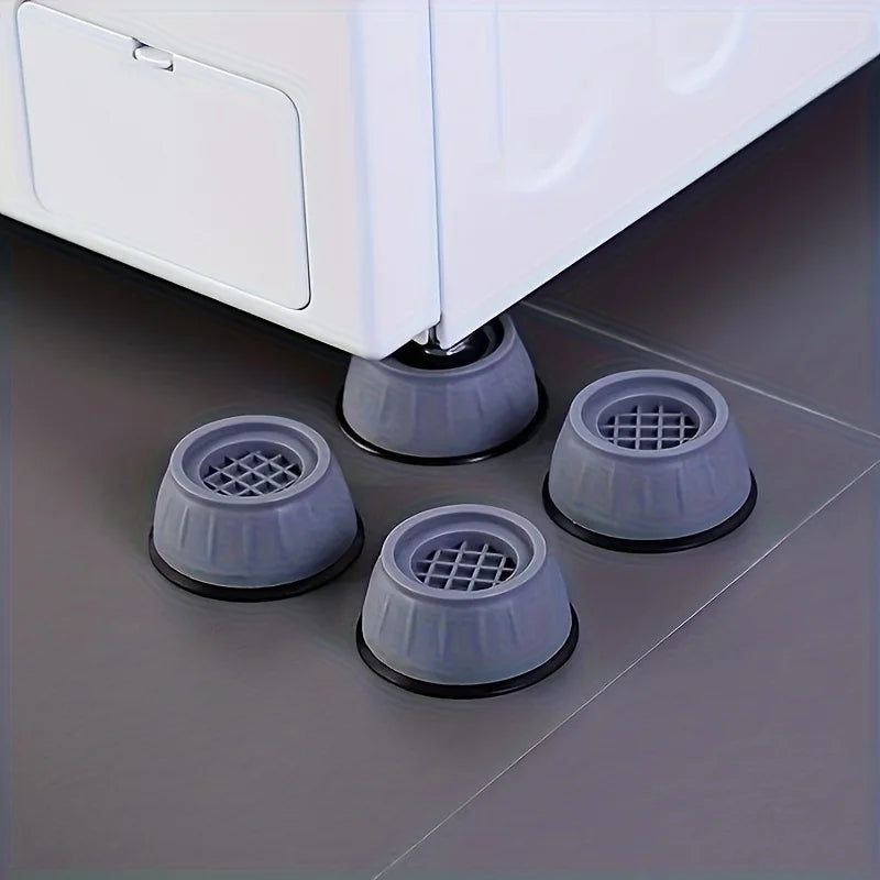 Three gray anti-vibration pads are shown under a white washing machine appliance.