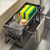A black kitchen sponge holder and drain rack with a hanging hook displaying yellow and green sponges.