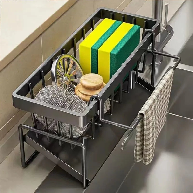 A black kitchen sponge holder and drain rack with a hanging hook displaying yellow and green sponges.