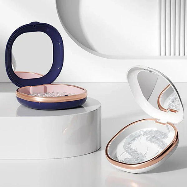 A compact dental retainer case with a purple bowl and a built-in mirror is displayed on a white surface.