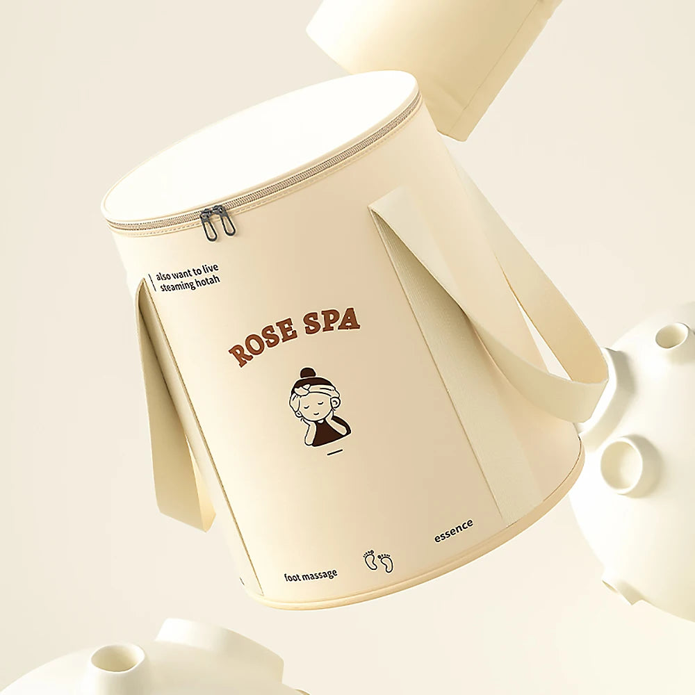A beige foldable aluminum foot bath bucket with a rose spa design and a handle.