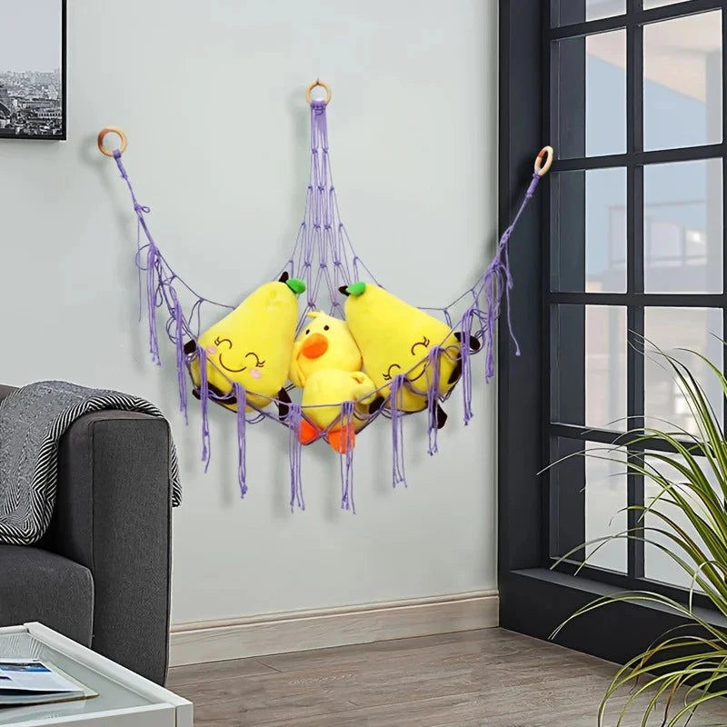 Yellow plush animal hammock storage net hanging on a wall