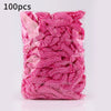 A package of 100 pink reusable transparent shower caps.