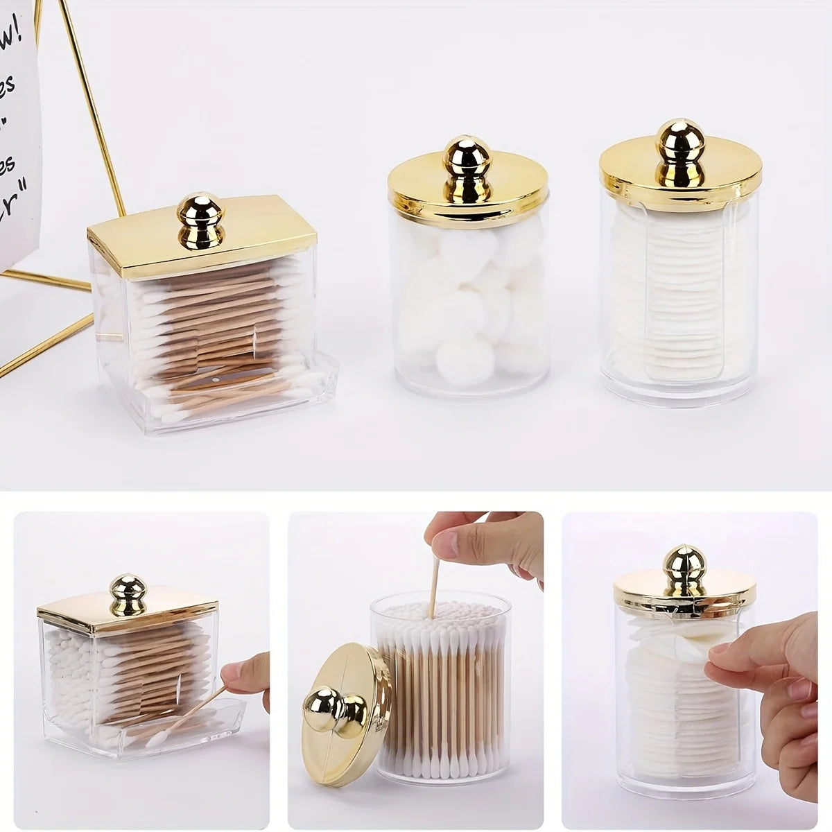 A clear glass apothecary jar dispenser with a golden lid holds cotton balls and swabs.
